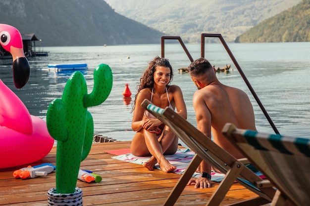 Cheerful couple sitting on the deck