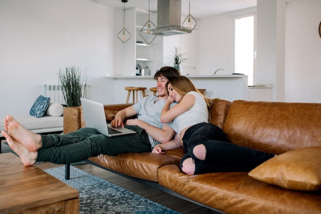 Cheerful couple on sofa