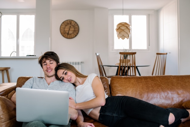 Cheerful couple on sofa