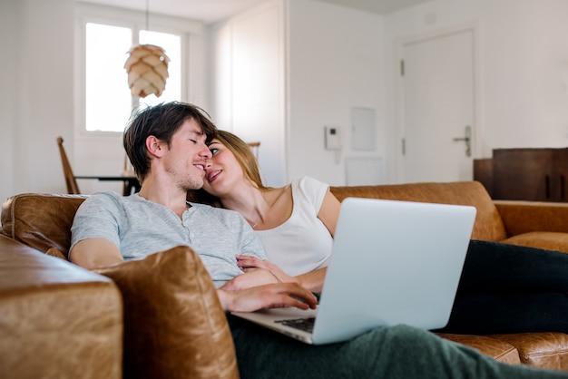 Cheerful couple on sofa