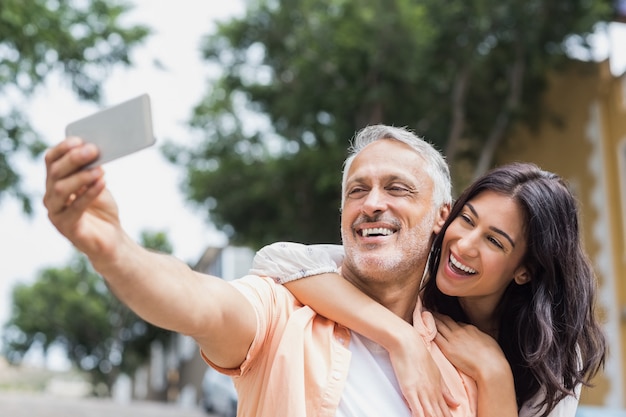 Cheerful couple taking selfie