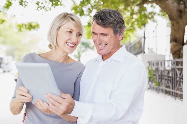 Cheerful couple using digital tablet