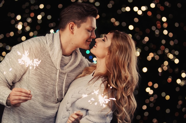 Cheerful couple in winter clothes hugging