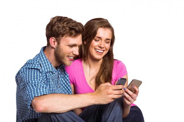 Cheerful couple with mobile phones