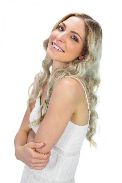 Cheerful curly haired blonde posing