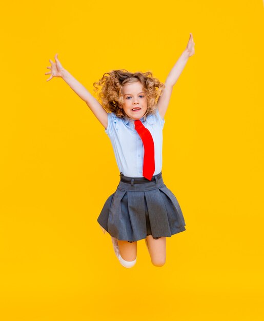 Cheerful cute genius positive little girl with curly hair
