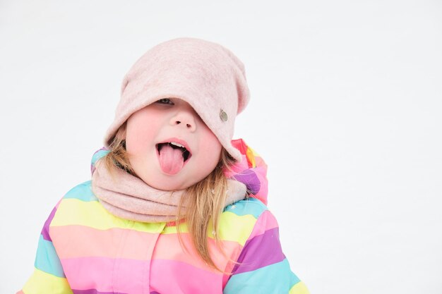 Cheerful cute girl 5 years old plays in the snow and makes funny faces