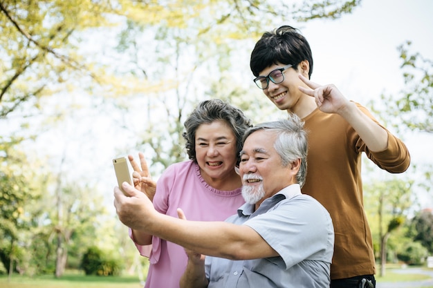 Cheerful disabled grandfather in wheelchair welcoming his happy family