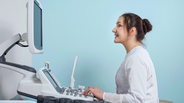 Cheerful doctor does ultrasonography to patient in hospital