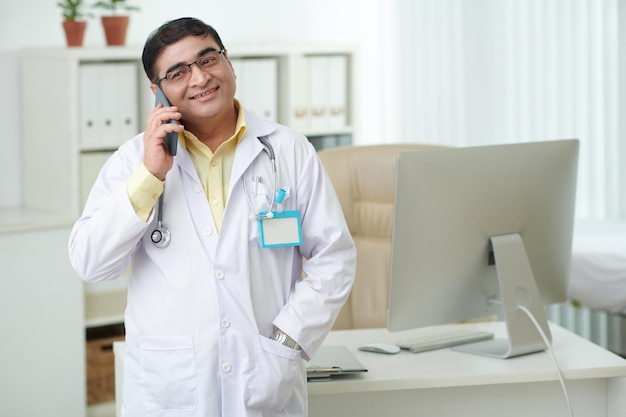 Cheerful Doctor Talking on Phone