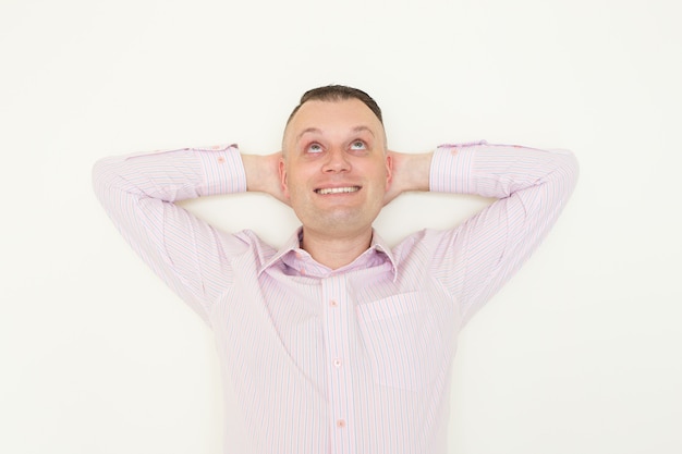 Cheerful dreamy young office employee thinking of successful career. 