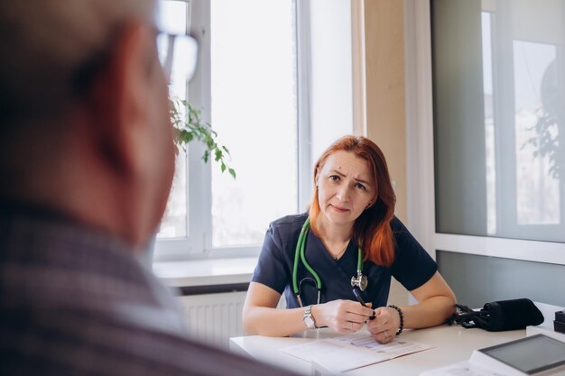 Cheerful elderly man being examined by a medical worker