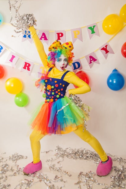 Cheerful emotional clowns at the party with paper disco