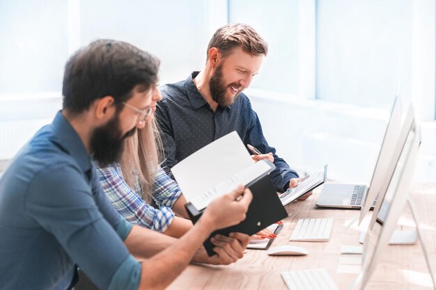 Cheerful employees discussing something at a meeting in the office . the concept of teamwork