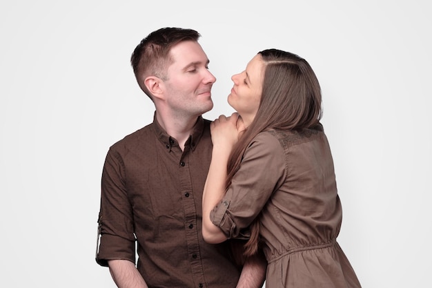 Cheerful european young couple in brown clothes