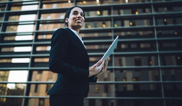 Cheerful executive woman with tablet