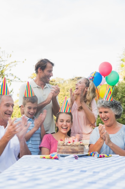 Cheerful extended family clapping for little girls birthday