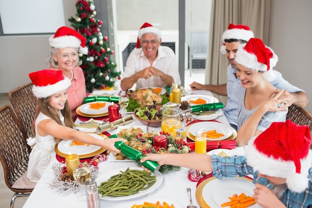 Cheerful family at dining table for christmas dinner