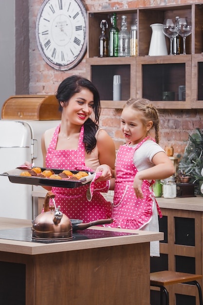 Cheerful family in the kitchen baking muffins or cupcakes