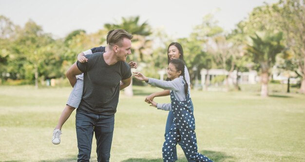 Cheerful family playing on field