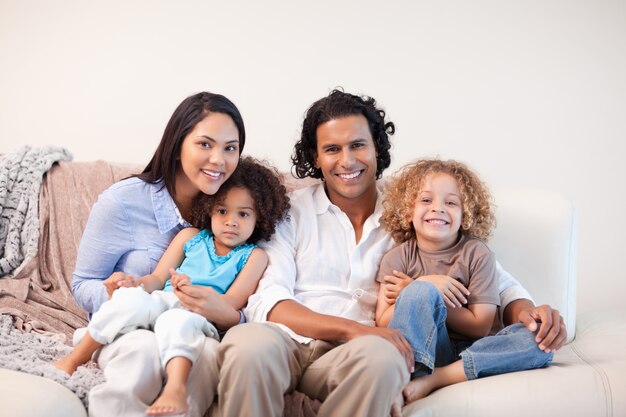 Cheerful family sitting on the sofa together