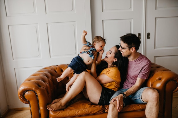 cheerful family on sofa at home