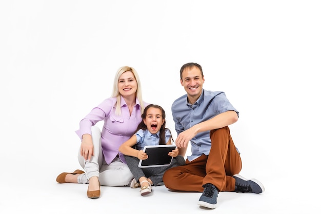 cheerful family using tablet computer isolated on white