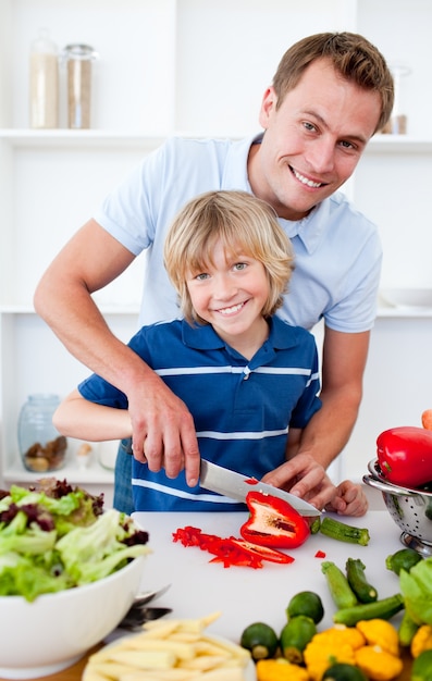 Cheerful father and his son cooking 