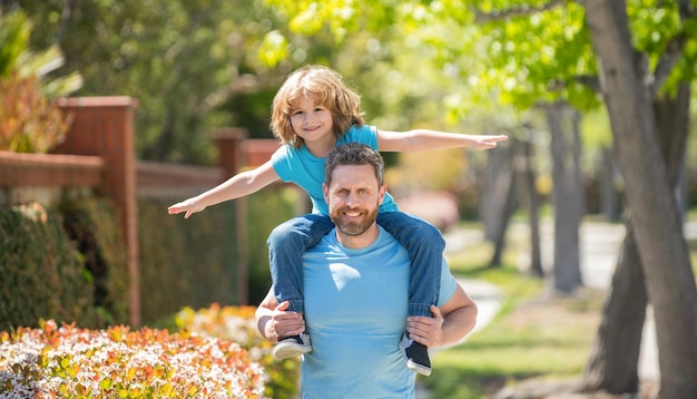 Cheerful father and son have fun in park family value childhood and parenthood