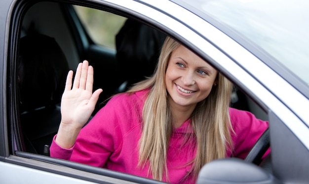 Cheerful female driver at the wheel 