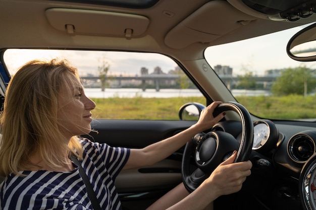 Cheerful female enjoying driving car