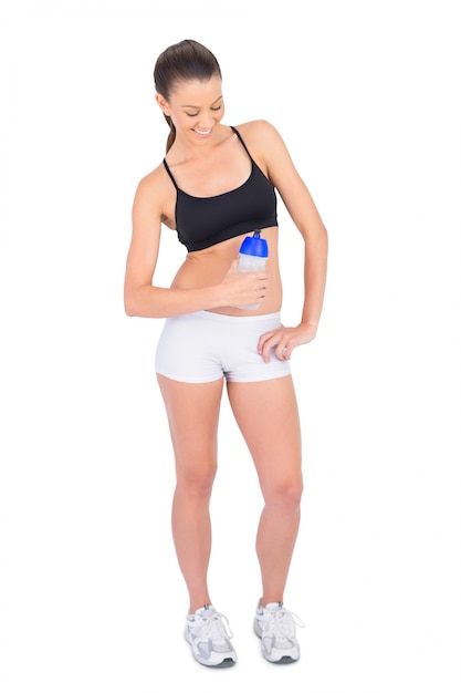 Premium Photo  Cheerful fit model in sportswear holding flask