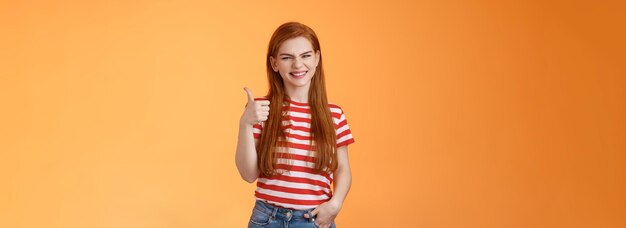 cheerful friendly woman red natural hair clean skin show thumb up smiling approval support perfect c