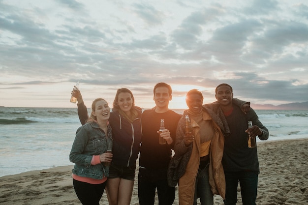 Cheerful friends drinking on the beach