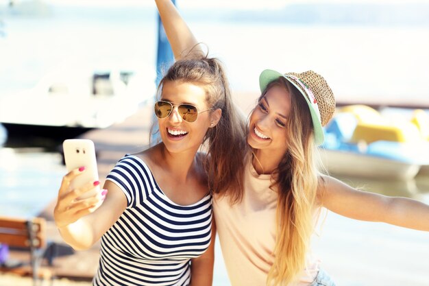 Cheerful friends having fun outdoors in summer