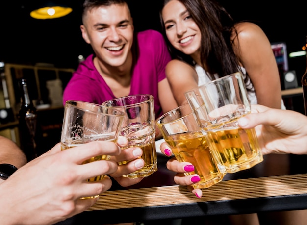 Cheerful friends in the pub. Drinking beer, talking, having fun.