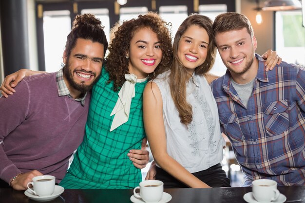 Cheerful friends sitting in cafe