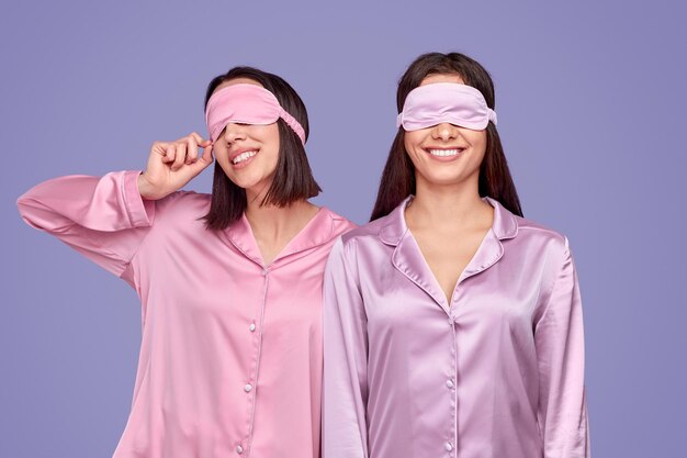 Cheerful friends in sleep masks