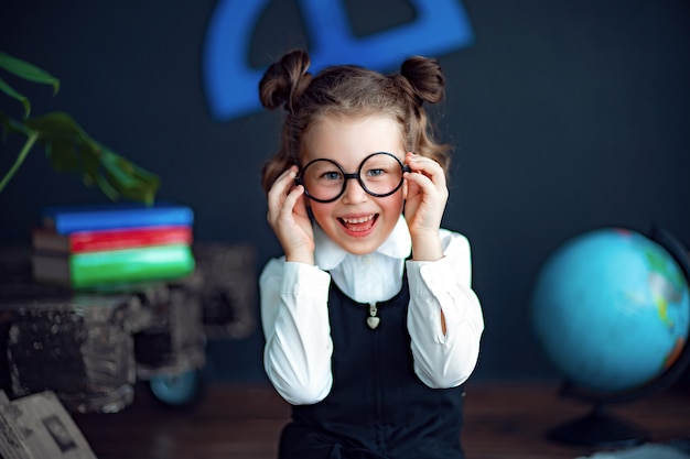 Cheerful girl adjusting glasses and smiling