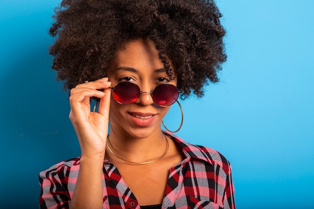 Cheerful girl enjoying life wearing sunglasses