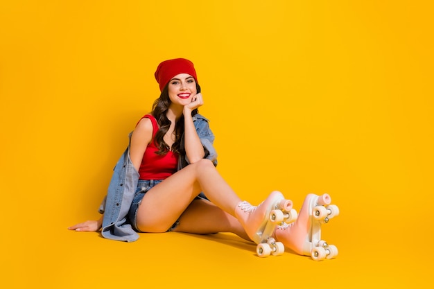 cheerful girl fit roller skater sit floor free time