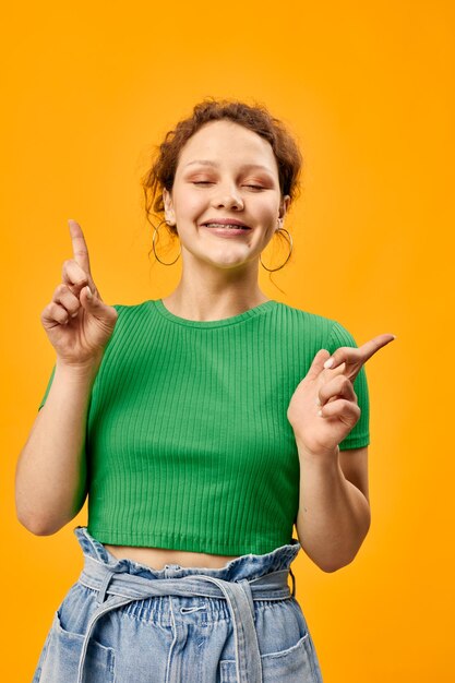 Cheerful girl in green tshirt earrings posing fashionable style