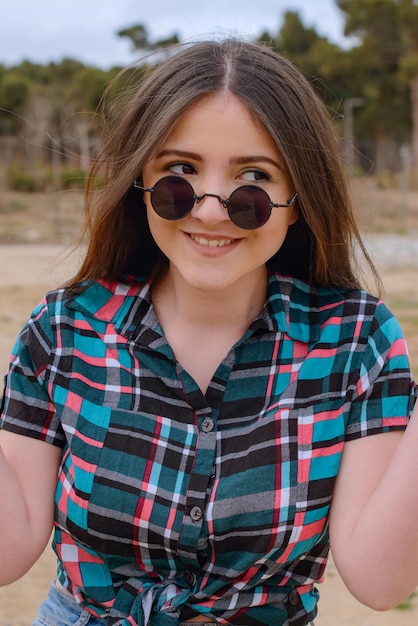 Cheerful girl holding her hands up and looking aside