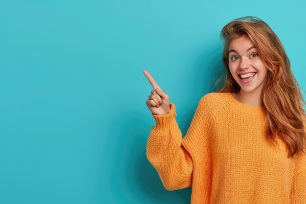 Фото cheerful girl pointing at empty space in colorful background