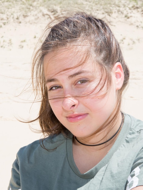 Cheerful girl on summer day wind in hairs