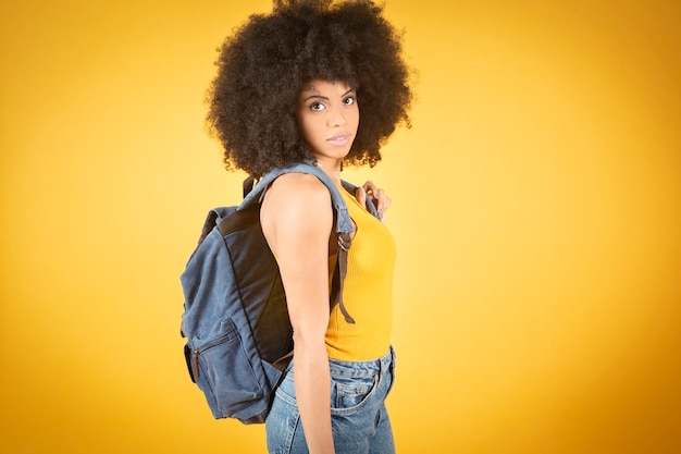 Cheerful girl walking with backpack and camera, mixed afro ameriacana, beautiful happy