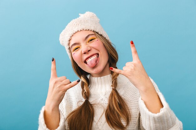 Cheerful girl wearing sweater standing isolated