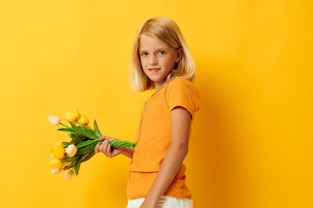 Cheerful girl with a bouquet of flowers fun gift holiday