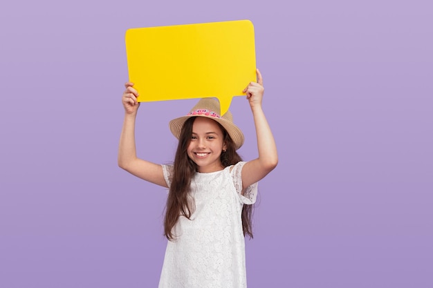 Cheerful girl with empty speech bubble on purple background