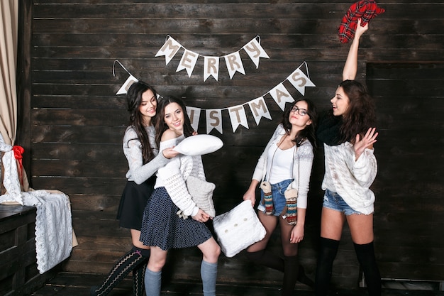 "Cheerful girl with pillows on Christmas party"